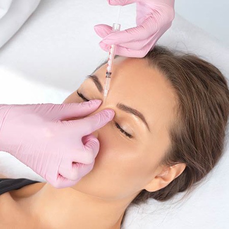 Female patient receiving BOTOX between her eyebrows