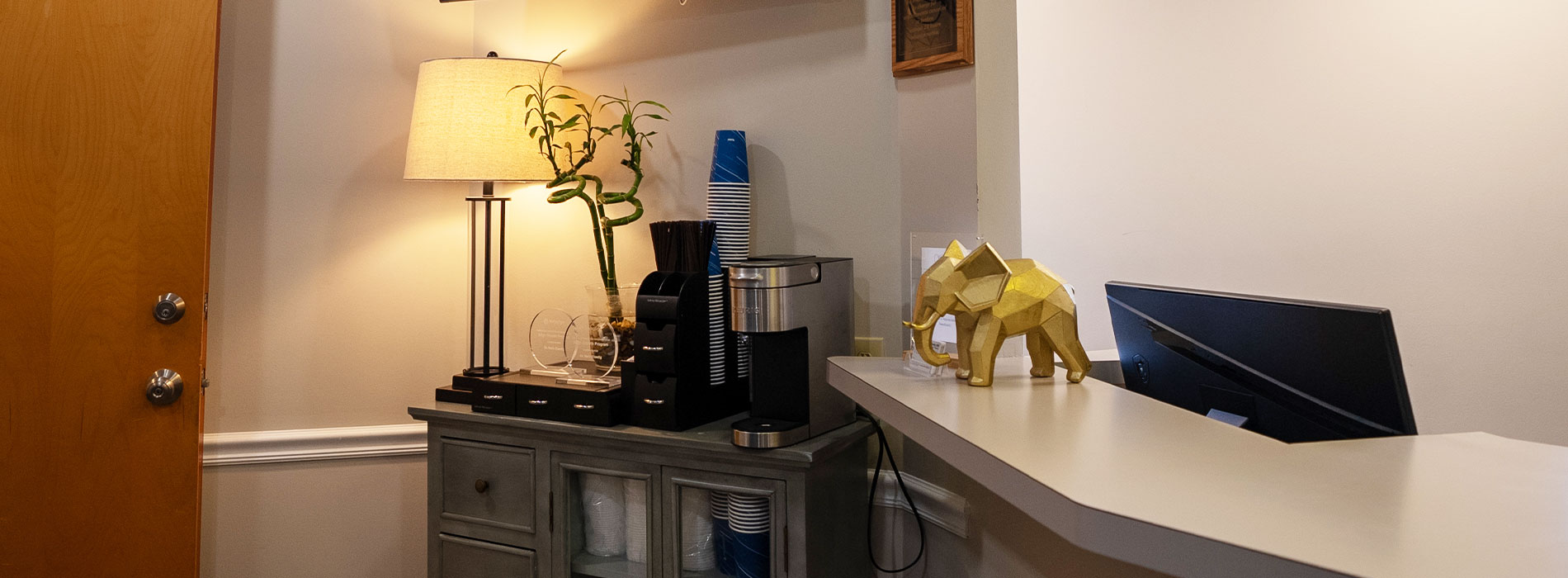 The image shows a modern dental clinic interior with various pieces of equipment, including a dental chair and an X-ray machine.