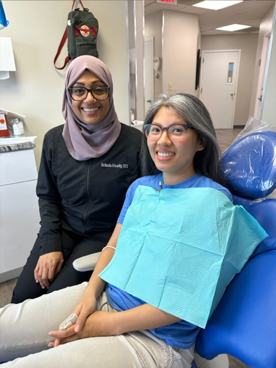 The image shows a modern dental or medical office interior with a dental chair, equipment, and a clean, professional environment.